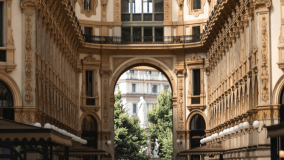 An archway in Milan leading to a statue