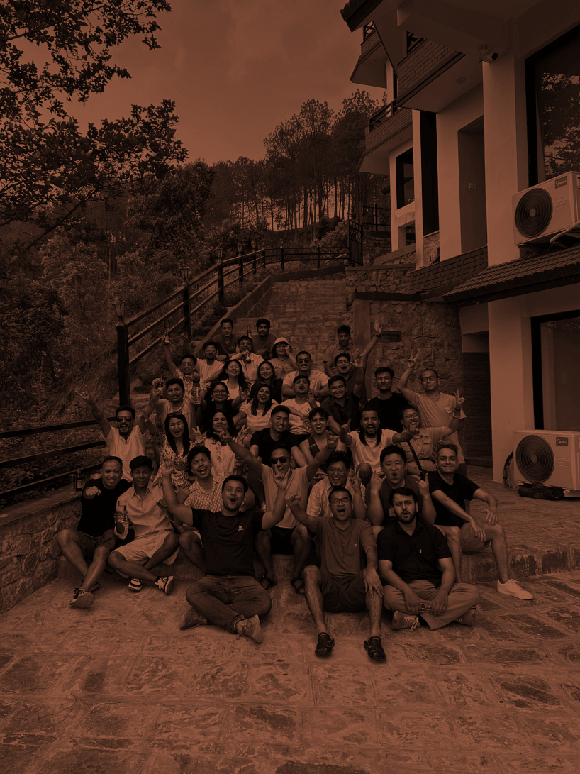 A group of Outside employees on the steps outside a building in Kathmandu